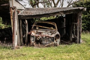 used car falling apart in a field